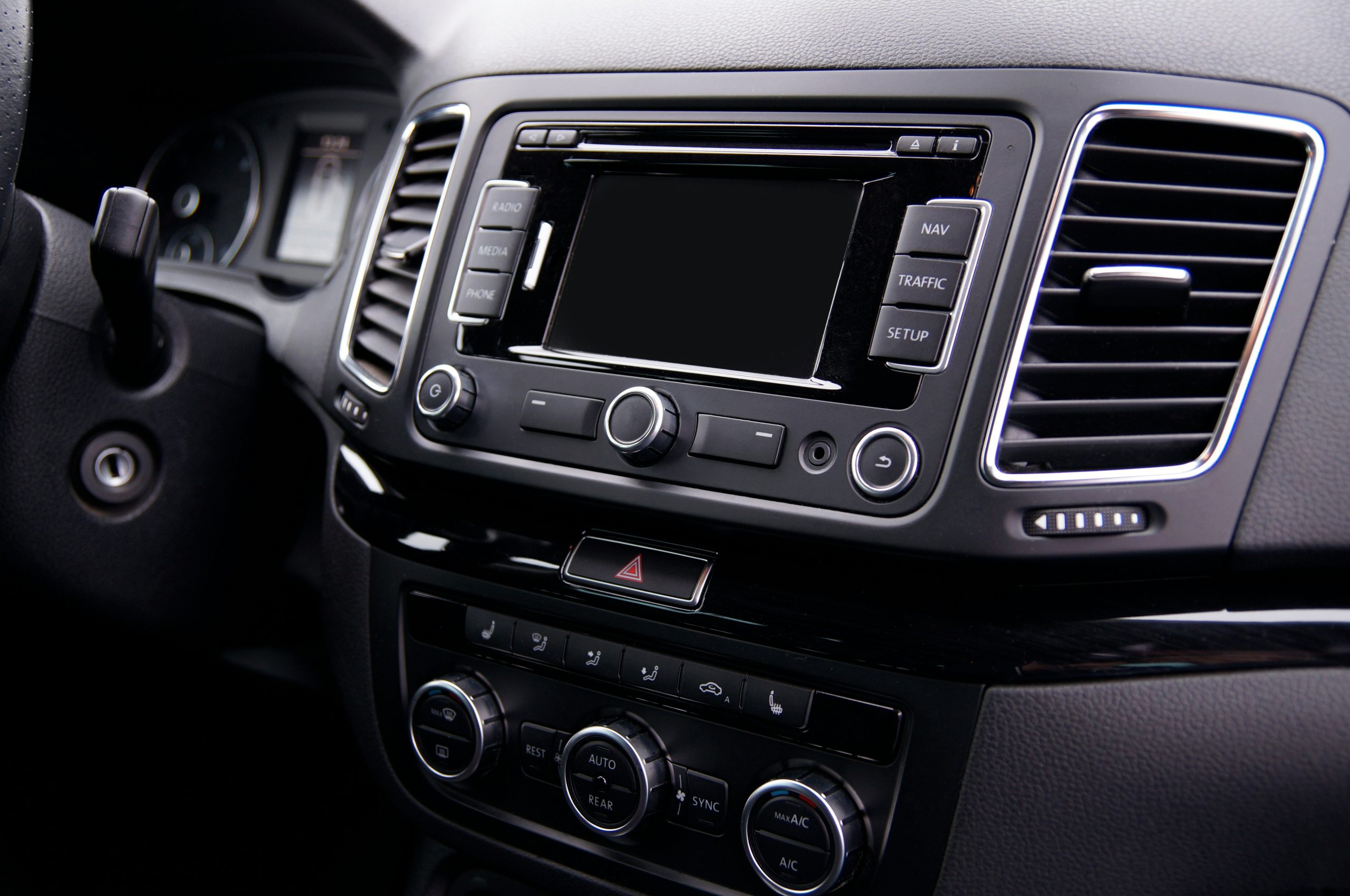 Car dashboard with an aftermarket head unit and touchscreen display.